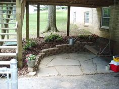 a covered patio with steps leading up to it