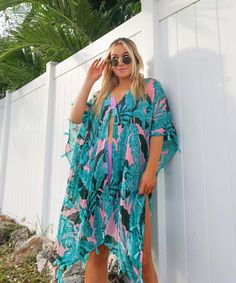 The ultimate tropical beach cover up for vacays and beach days, this cute swim cover up dress with tassel trim features a dreamy pink and green monstera leaf palm print. One size fit most. Hand wash & hang dry only Material: 100% Viscose Summer V-neck Cover-up With Tropical Print, Tropical Print Beachwear Cover-up For Pool, Green Swimwear For Summer Outings And Beach Season, Green Beachy Swimwear For Summer Outings, Pink Beachy Swimwear For Summer Outings, Beachy Tropical Print Swimwear For Beach Cover-up, Hawaiian Swimwear For Beach Season, Pink Beachwear Swimwear For Summer Outings, Tropical Cover-up For Summer Beach Outings