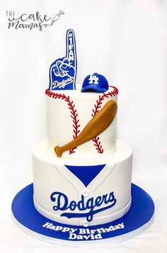 a birthday cake with a baseball bat and glove on the top is for a dodgers fan