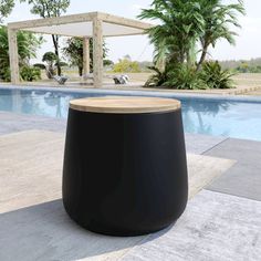 a black stool sitting next to a swimming pool