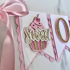 a pink and white greeting card with a cupcake on it that says sweet 50