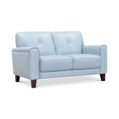 a light blue couch sitting on top of a white floor next to a red frame