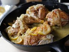 chicken with lemons and onions in a skillet