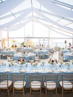 the tables are set up with blue linens