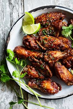 chicken wings with cilantro and lime on a plate