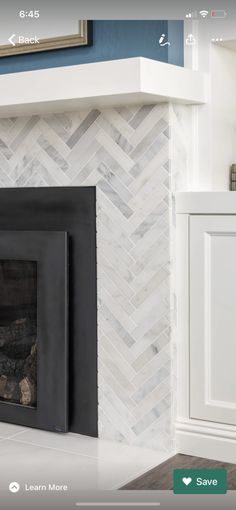 a fireplace with white and gray tile on it