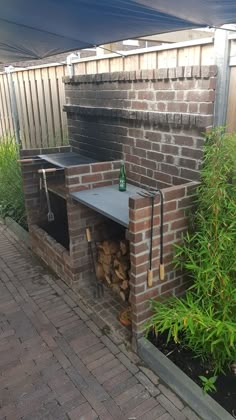 a brick oven sitting in the middle of a garden