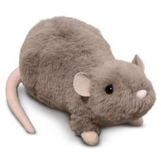 a stuffed rat is laying down on the ground