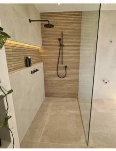 a walk in shower sitting inside of a bathroom