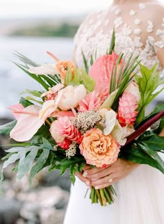 a woman holding a bouquet of flowers in her hands