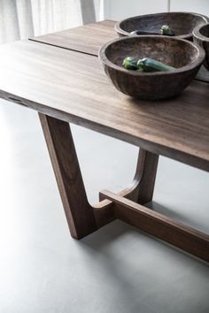 three bowls are sitting on a wooden table