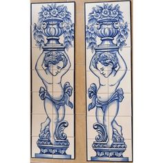 two blue and white tile panels with cherubs holding vases on each side