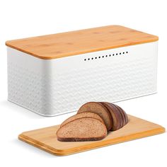 a loaf of bread sitting on top of a cutting board next to a slice of bread