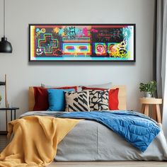 a bed with colorful pillows and blankets on top of it next to a wall mounted painting