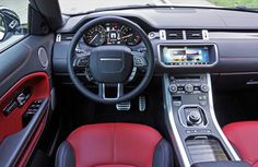 the interior of a sports car with red leather seats and dash lights, including steering wheel