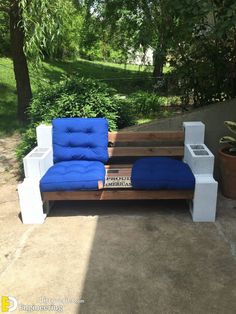 a blue couch sitting on top of a wooden bench