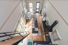 an aerial view of a living room and kitchen from the top floor in a loft