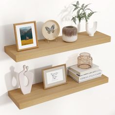 two wooden shelves with pictures, vases and other decorative items on top of them