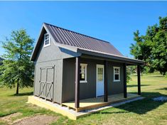 a small gray house with a metal roof