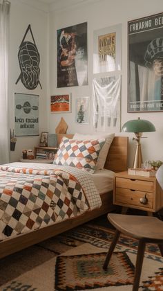 a bedroom with posters on the wall and a bed in front of a window that has a checkered comforter