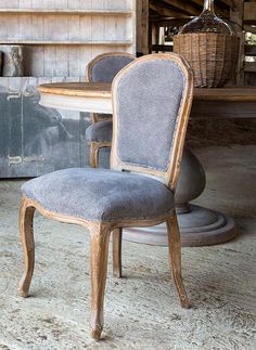 an old chair sitting in front of a table