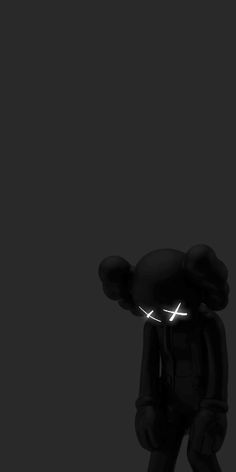 a black teddy bear with glowing eyes in the dark