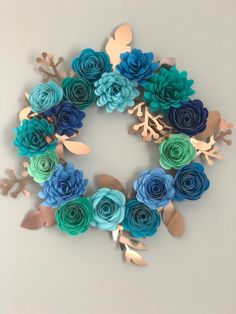 paper flowers are arranged in the shape of a wreath