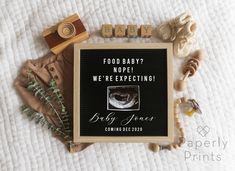 a baby announcement surrounded by toys and other items on a white sheet with the words foodbaby? nope i've expecting