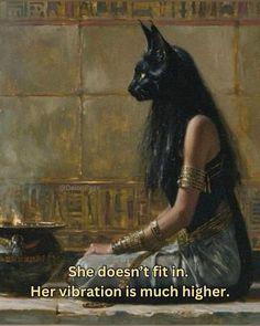 an egyptian woman sitting in front of a black cat