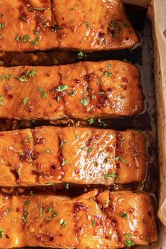 meatloaf with sauce and parsley on top in a brown baking dish, ready to be eaten