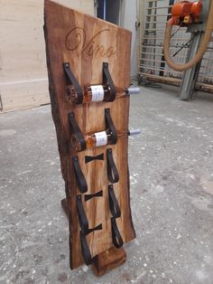 a wooden wine rack with six bottles on it