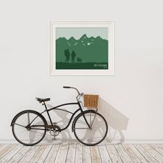 a bike is parked in front of a white wall with a mountain scene on it