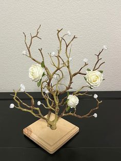 a vase filled with white flowers sitting on top of a table