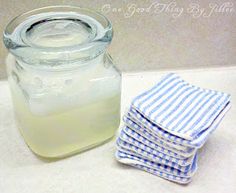 a glass jar filled with liquid sitting on top of a table next to napkins