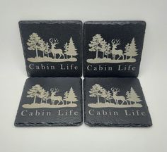 three coasters with the words cabin life and trees on them, sitting next to each other