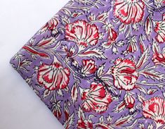 a purple tie with red and white flowers on it