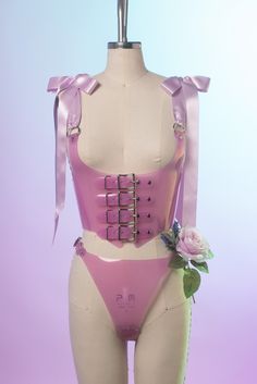 The pastel version of the Antoinette Buckle Harness Bodice is inspired both by 90s goth and Rococo stays. Four straps buckle in front just underneath the bust/chest. Double faced wide satin ribbon shoulder straps tie at the shoulders into bows. This is machine stitched with matching heavy duty thread. Laces up the back with grommets more satin ribbon. Available in pastel blush pink or light purple PVC. This material is slightly translucent. Silver-toned nickel plated steel hardware. Shown with m Pvc Corset, Harness Outfit, Pastel Jacket, 90s Goth, Rave Girl, Pink Corset, Cosplay Diy, Hilarious Memes, Pink Outfits