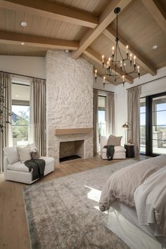 a large bedroom with a fireplace, couch and chair in it's center area