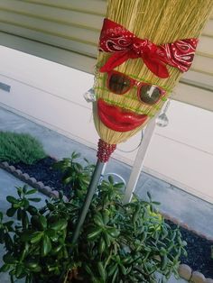 a broom with a face and sunglasses on it