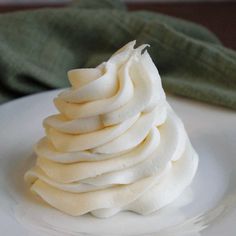 a white plate topped with whipped cream on top of a table