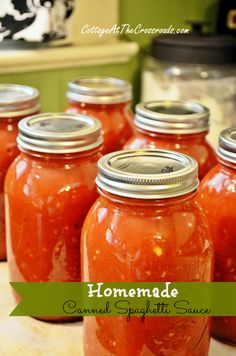 several jars filled with red liquid sitting on top of a table