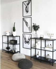 a living room filled with furniture and pictures on the wall next to a coffee table