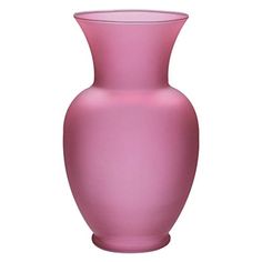 a pink vase sitting on top of a white table