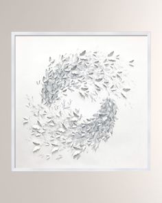 a white framed artwork with many birds flying in the air over it's surface