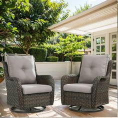 two chairs sitting on top of a wooden deck