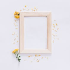 yellow flowers are scattered around a wooden frame