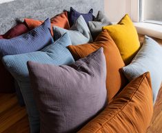 a bunch of pillows sitting on top of a couch