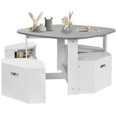 a white table with two storage bins underneath it and an open book shelf below