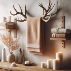 towels, candles and deer antlers hang on the wall