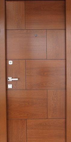 an open wooden door with metal handles